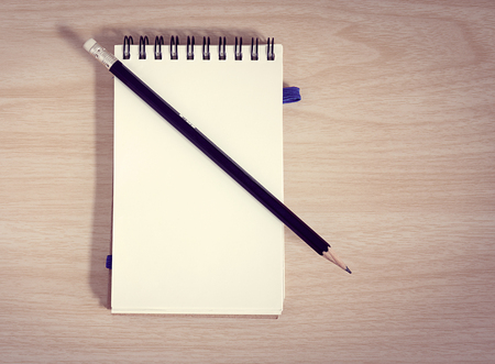 notebook with a pencil on wooden backgroundの写真素材