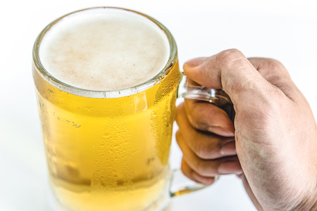 man hand holdin frosty glass of light beer for drinking on a white backgroundの写真素材
