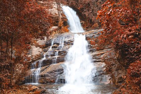 Wonderful autumn waterfall in deep forest at national park, Thailandの写真素材