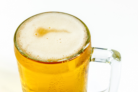 Frosty glass of light beer on a white backgroundの写真素材