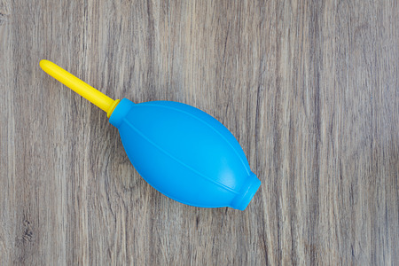 Blue rubber pear on a wooden backgroundの写真素材