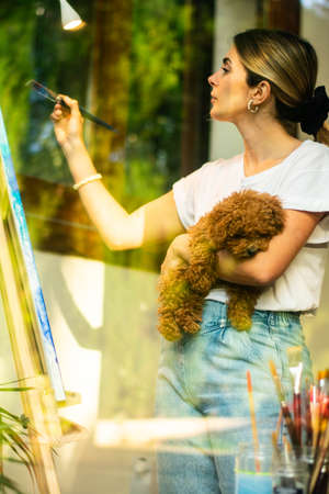 young blonde girl in Virtual class art in modern living roomの写真素材