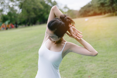 Woman do yoga and relaxation in garden. Woman exercising vital and meditation for fitness lifestyle at the nature background. Concept Yogaの写真素材