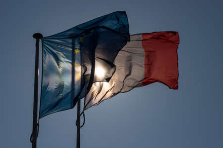 French flag waving in the wind against the blue sky. High quality photoの写真素材