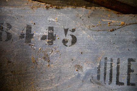 A closeup shot of a rusty metal plate with the numbers on itの写真素材