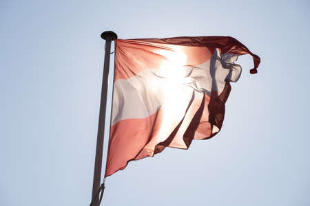 Poland flag waving in the wind against the blue sky. High quality photoの写真素材