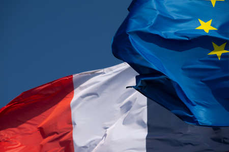 Two flags of the European Union and France waving in the wind.の写真素材