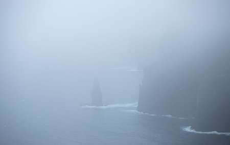 The Cliffs of Moher in Ireland in rain and foggy weather