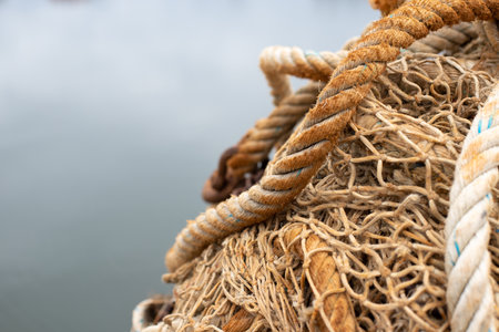 Close up of fishing nets and ropes on a boat in the harborの写真素材