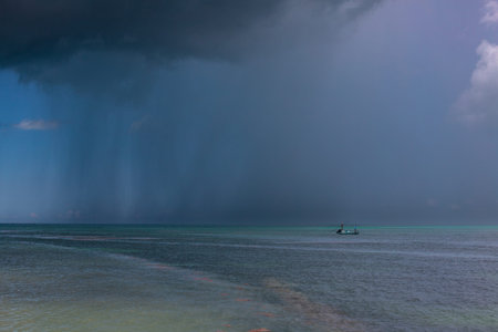 Rain storm in the sky over the sea with fisherman boat, Thailand