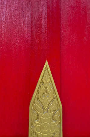 Thai art from wood carving on red wallの写真素材