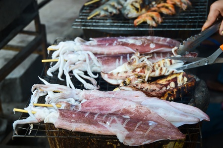 Many of grilled squid in the seafood market の写真素材