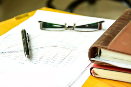 ballpoint pen with documents and graph data