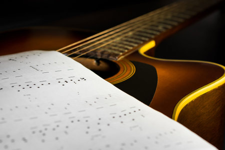 steel string acoustic guitar with song note paper