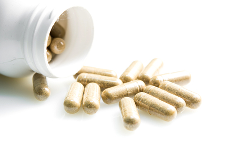 Herb capsule on a whiteの写真素材