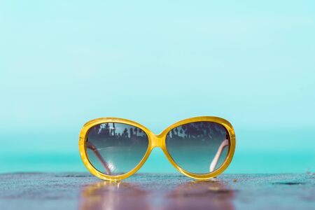 Sunglasses with sea backgroundの写真素材
