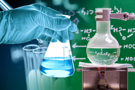 Flask in scientist hand with laboratory backgroundの写真素材