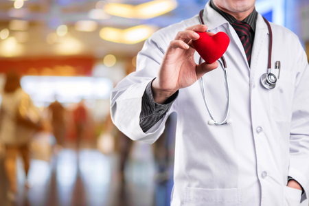 Doctor holding red heartの写真素材