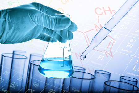 Flask in scientist hand with dropping liquid to test tube, Chemical, scientific research and development conceptの写真素材