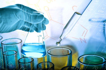 Flask in scientist hand with dropping liquid to test tube, Chemical, scientific research and development conceptの写真素材
