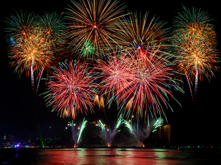 Beautiful colorful firework display on the sea for celebration nightの写真素材