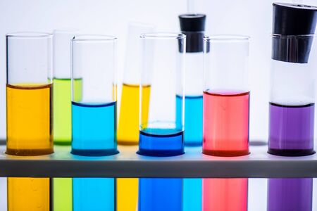Lab glassware containing chemical liquid with laboratory background, science research and development conceptの写真素材