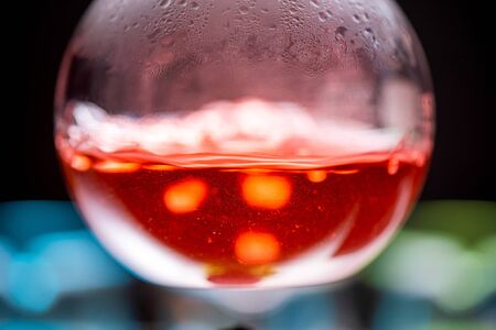 Lab glassware containing chemical liquid with laboratory background, science research and development conceptの写真素材