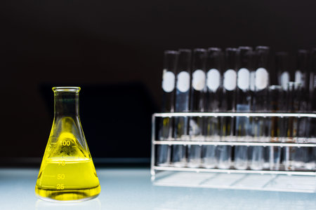 Lab glassware containing chemical liquid with laboratory background, science research and development conceptの写真素材