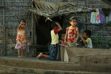 CAMBODIA - APRIL 2005  Cambodian children play together near their house in the fishing village of Tonle Sap Lake around April 2005 in Cambodia  Living conditions in the area are difficult のeditorial素材
