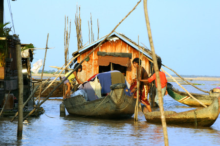 CAMBODIA - APRIL 2005  Cambodian family is about to boat near the fishing village of Tonle Sap Lake around April 2005 in Cambodia  Living conditions in the area are difficult  のeditorial素材