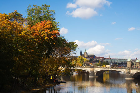 View of Pragues river in autumn and the castle in the distanceの写真素材
