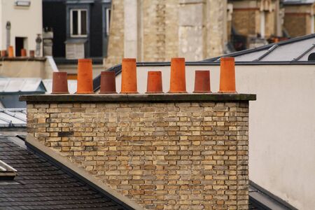 Parisian heating chimney, roofs and briwk wallsの写真素材