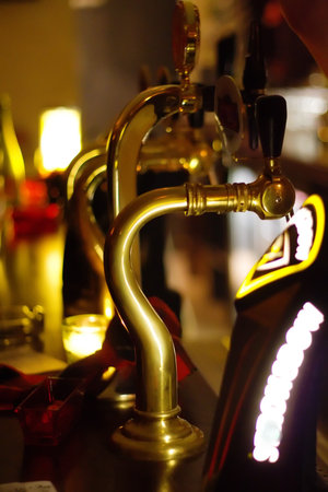 Copper taps in a pub, in a warm atmosphereの写真素材