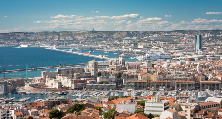 A landscape of Marseille from above with the see and mountains and white clouds in the backgroundの写真素材