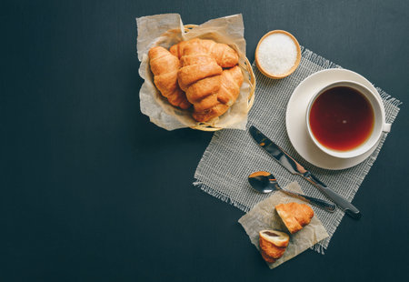 Homemade croissant served with black coffee or americano. Delicious breakfast with fresh croissant. Croissant and  coffee. copy space. Croissant and coffee for coffee break. Top view. Flat lay.の写真素材