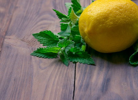 Lemon and mint, close-up. Citrus on a wooden table. Vitamins. Immunity. Concept alternative medicine, natural homemade remedy for cold and flu. Support the immune system. Well-Being and Healthy.の写真素材
