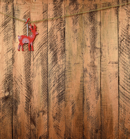 Fabulous red-nosed reindeer on a wooden background. Christmas background. New Year. Tradition and childhood.の写真素材