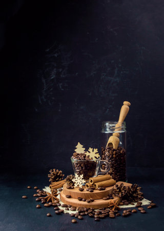 A mug with hot aromatic coffee.Winter holidays concept. Coffee and snowflakes, pine cones and spices. Cinnamon and star anise. Love of coffee and home comfort in the winter cold. Hygge.の写真素材