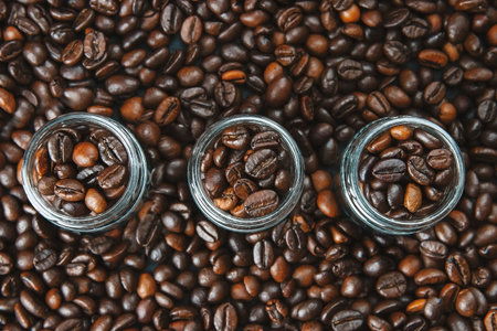 A cup of coffee on beans texture background. Top view of roast grains.Top view flat lay with copy...
