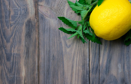 Lemon and mint, close-up. Citrus on a wooden table. Vitamins. Immunity. Concept alternative...