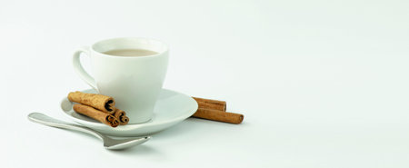 Coffee with cinnamon. A cup of fragrant hot drink on a light gray background. Breakfast. Good morning concept. The concept of winter holidays and hot drinks with spices. Top view. Mockup.の写真素材