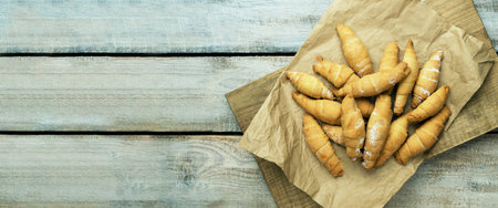 Fresh croissants on parchment paper. Crispy croissant. French pastry concept. Fresh croissants on...