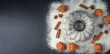 Homemade classic sponge cake or biscuit sprinkled with powdered sugar. Bakery background concept....