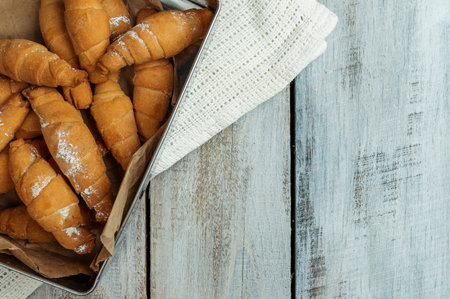 Fresh croissants with cheese. traditional homemade French pastries for breakfast. Baked sweet croissant. Delicious breakfast with fresh croissant on the wood table. Bagels. Homemade baking.の写真素材