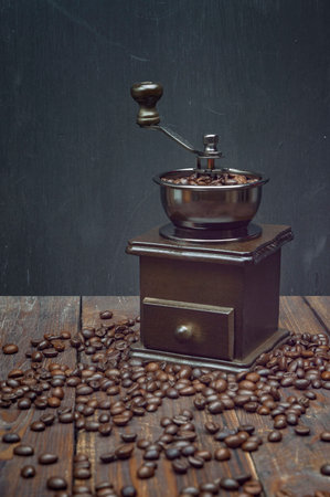 grinder, coffee beans. Roasted coffee beans in a coffee grinder. wooden background, copyspace.の写真素材