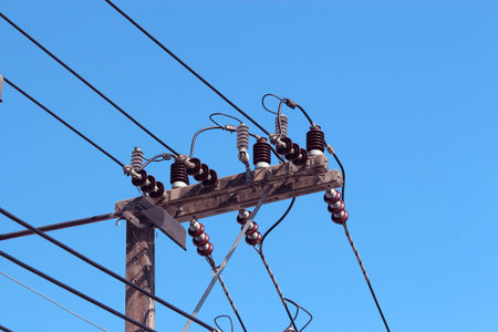 Power lines and power poles in the bright sky.