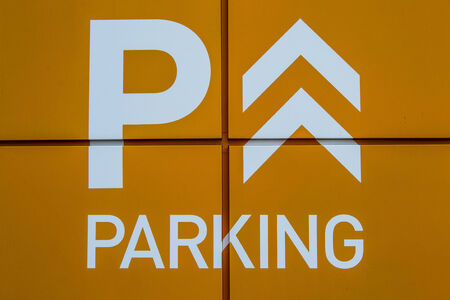 Bright Orange Parking Sign Close-Up