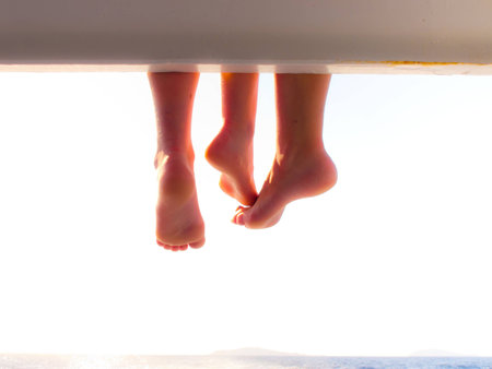 Relaxed foot lying on the boatの写真素材