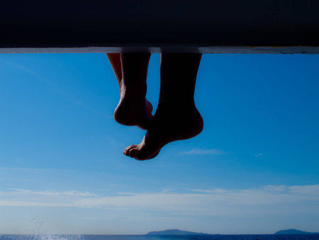 Relaxed foot lying on the boatの写真素材