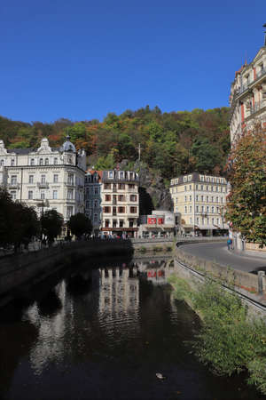 CZECH REPUBLIC, KARLOVY VARY, MIROVE NAM. - MARIANSKOLAZENSKA, OCTOBER 04, 2018: Buildings are mirroring in the river Tepla.のeditorial素材